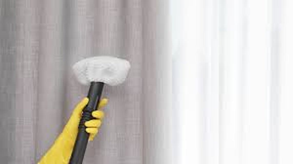 A curtain being refreshed with a garment steamer