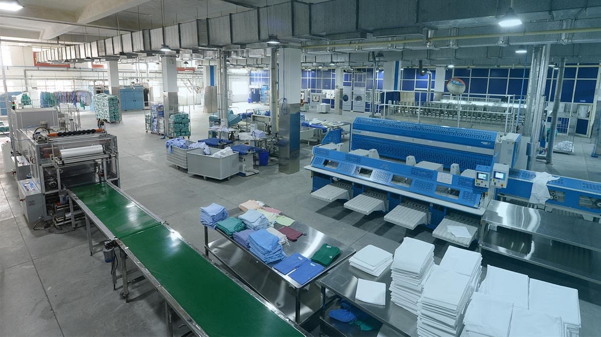Finishing tables with neatly folded linen at a laundry facility