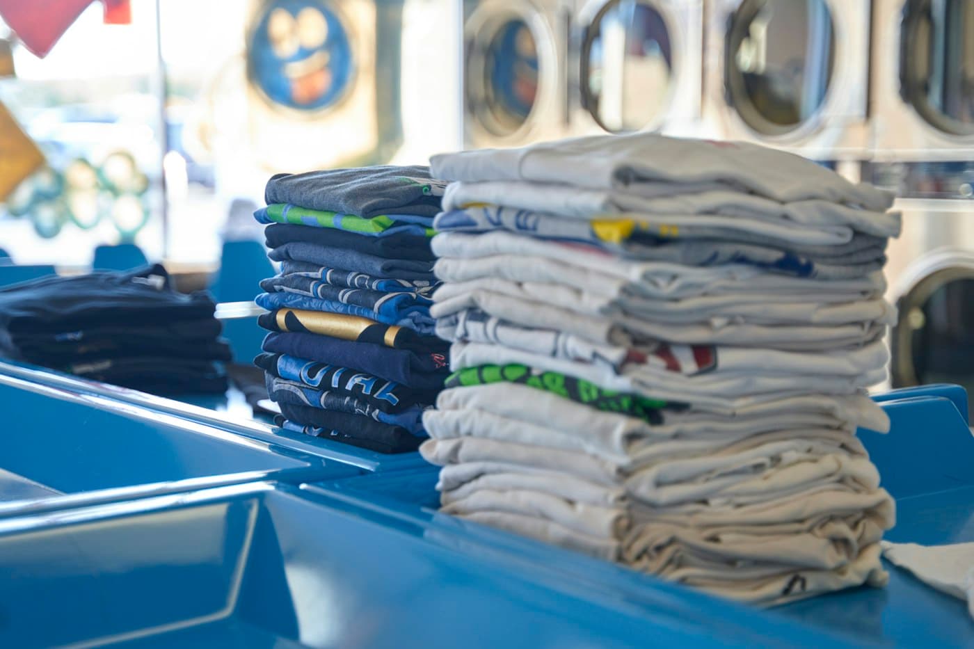 Neatly folded shirts stacked and ready for delivery